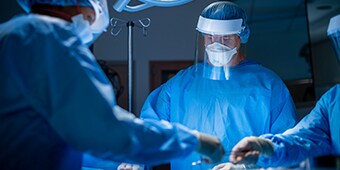 Three Surgeons providing surgical care
