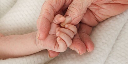 Person, der holder en babys fingre
